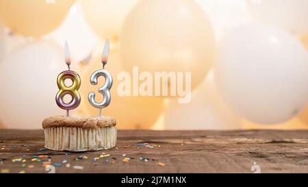 Happy birthday card with a candle in a cupcake against the background of balloons. Copy space happy birthday with cupcake digit Stock Photo