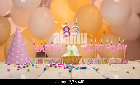 Beautiful background happy birthday number with lit candles, birthday candles in pink letters. Festive background with balloons Stock Photo