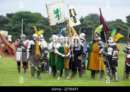 men and women waiting at side of battle field during a re enactment Stock Photo