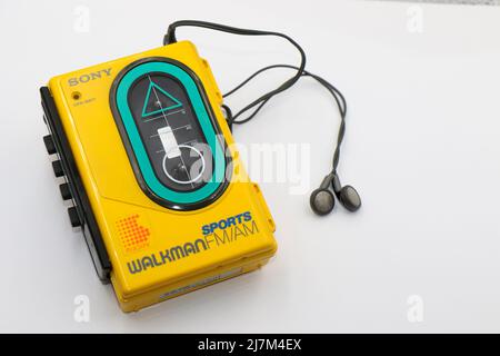 Sony Sports Walkman radio cassette player. Retro vintage portable audio music device1980s. Earphones or in-ear headphones attached. Stock Photo