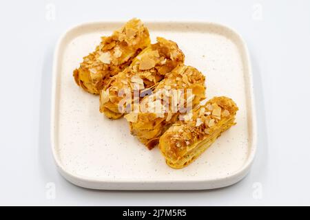 Cream eclairs cake. Eclair cake with cream filling on a white background. close up Stock Photo