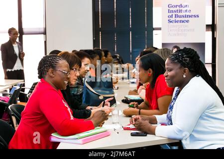 Johannesburg, South Africa - November 20, 2014: Diverse students networking at College Campus Stock Photo