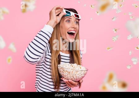 Photo of funny excited woman wear striped outfit 3d eyewear watching movie eating pop corn isolated pink color background Stock Photo