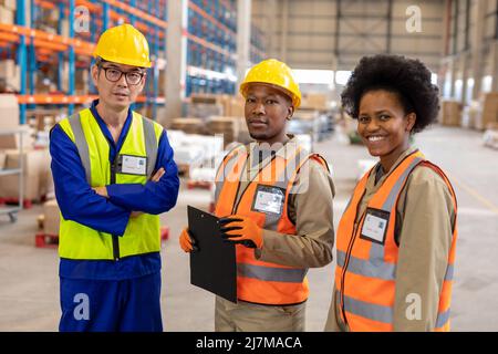 Portrait of asian mature male foreman standing with african american young male and female coworkers Stock Photo