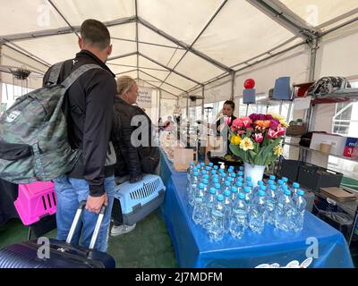 May 9, 2022, PrzemyÅ›l, Poland: PrzemyÅ›l Glowny ''” Main train station ''” May 9, 2022: Ukrainian refugees arrive with pets in carriers and luggage to eat and rest at the World Central Kitchen tent. A bouquet of flowers towards the entrance add a sweet and welcoming touch on Mother's day. (Credit Image: © Amy Katz/ZUMA Press Wire) Stock Photo