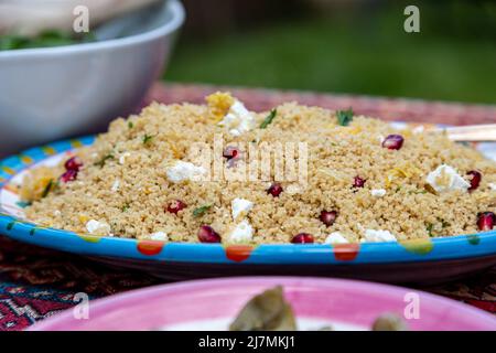 Cous cous and salad on a table in the garden, ready for a party Stock Photo