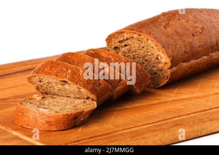 Sliced rye baguette on a wooden board Stock Photo