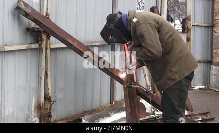KYIV, UKRAINE 01 March. A member of Territorial defense forces makes Czech-style tank barricades by welding together rusted scrap metal in Protasiv Yar neighborhood, as Russia's invasion of Ukraine continues on 01 March 2022 in Kiev, Ukraine. Russia began a military invasion of Ukraine after Russia's parliament approved treaties with two breakaway regions in eastern Ukraine. It is the largest military conflict in Europe since World War II. Stock Photo