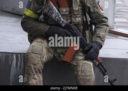 KYIV, UKRAINE 01 March. A member of the battalion of the Territorial Defence Forces of Ukraine's former president Petro Poroshenko holds an AK-47 rifle on 01 March 2022 in Kiev, Ukraine. Russia began a military invasion of Ukraine after Russia's parliament approved treaties with two breakaway regions in eastern Ukraine. It is the largest military conflict in Europe since World War II. Stock Photo
