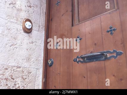 detail of a old ceramic doorbell on the wall of a door of a Castilian house Stock Photo