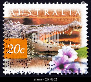 AUSTRALIA - CIRCA 1997: a stamp printed in the Australia shows Saltwater Crocodile and Kangkong Flower, Crocodylus Porosus, circa 1997 Stock Photo