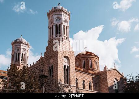 Greek Orthodox Church of Holy Church of the Dormition of the Virgin Mary Chrysospileotissa in Athens. Exterior of historical orthodox church. Stock Photo