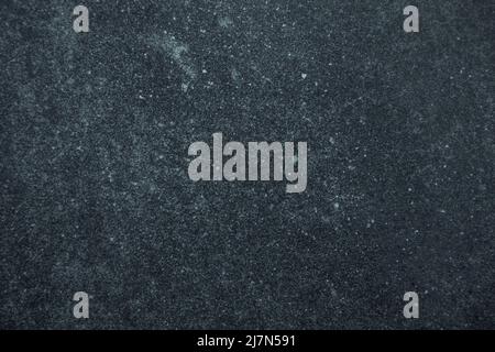 Dark worn blue and black stained surface background or texture Stock Photo