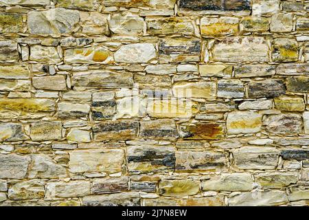 closeup background with a fragment of an ancient limestone brick wall Stock Photo