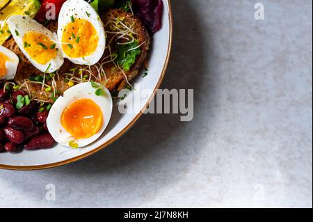 Medium boiled eggs with sasld, healthy breakfast Stock Photo