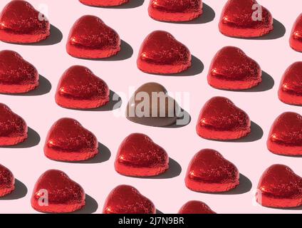 Pattern of chocolate bars shape heart, against pink background Stock Photo