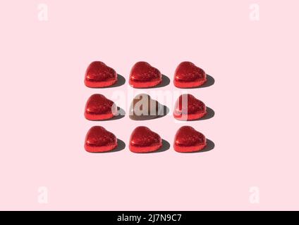 Pattern of chocolate bars shape heart, against pink background Stock Photo