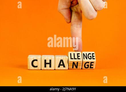 Chance or challenge symbol. Businessman turns wooden cubes and changes the concept word challenge to chance. Beautiful orange table orange background. Stock Photo