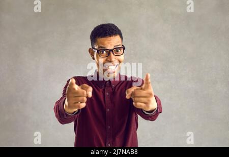 Portrait of happy black man smiling and doing You're Right or I Choose You gesture Stock Photo