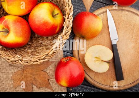 sliced colorful apple on wood background top view Stock Photo