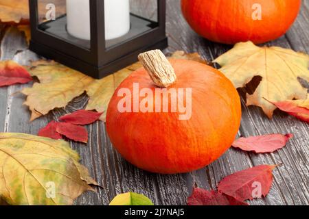 squash and autumn leaves on wood background Stock Photo