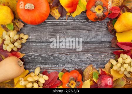 autumn leaves fruits vegetable frame on wood background Stock Photo