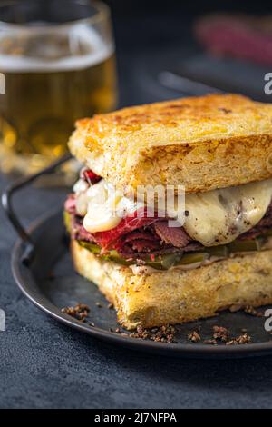 Sandwich with beef pastrami on wooden board Stock Photo