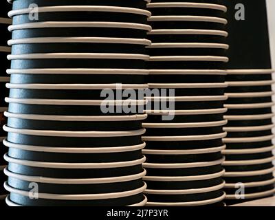 Stacks of the dark disposable paper cups, background Stock Photo