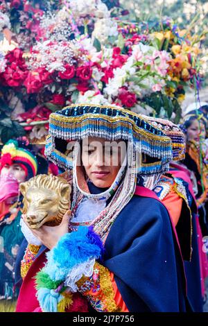 Choquekillka Festival procession. Woman carrying Señor de Choquekillka image in the Peruvian Sacred Valley city of Ollantaytambo. Stock Photo