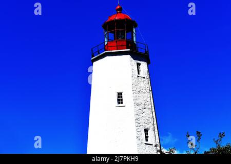 FIRST WATCH: Sandy hook light of NJ was completed in 1764 and is the oldest operating lighthouse in the US located on the Fort Hancock military base. Stock Photo