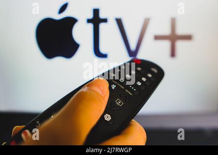 Brazil. 10th May, 2022. In this photo illustration a close-up of a hand holding a TV remote control in front of the Apple TV  (Plus) logo on a tv screen. (Photo by Rafael Henrique/SOPA Images/Sipa USA) Credit: Sipa USA/Ģ����ý Live News Stock Photo