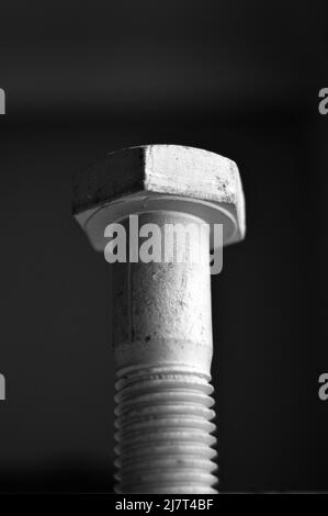 Galvanized steel metal with metric bolt, isolated on black background Stock Photo