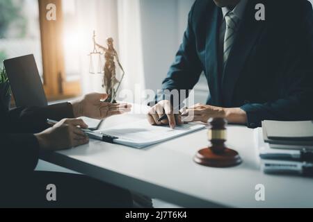 Law, Consultation, Agreement, Contract, Attorney or Lawyer holding a pen is consulting with a client to explain the pattern of answering questions Stock Photo