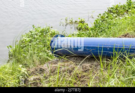 Endpoint of a dredging pipeline near the river close up shot Stock Photo