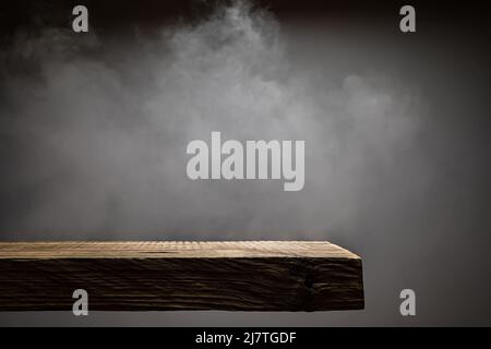 Wood plank podium with smoke in the dark Stock Photo