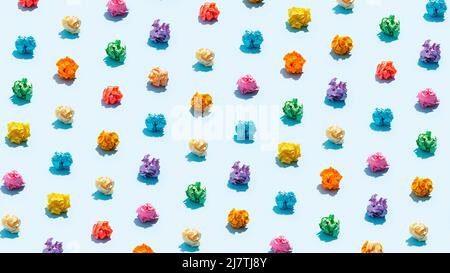 Multicolored crumpled paper balls on blue Stock Photo