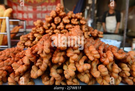 Mahua Chinese biscuits sold at a large colorful fresh produce market in chaoyangmen, Beijing, China. Stock Photo