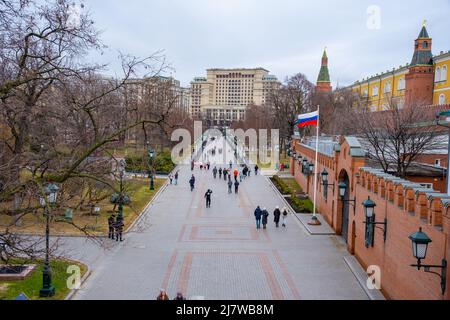 Moscow, Russia - April 10, 2022: People walking in Alexander Garden nearby Kremlin wall in Moscow, Russia Stock Photo