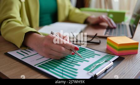Analyst employee working with financial report on computer and documents Stock Photo