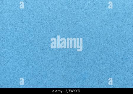 Texture of old light blue paper closeup. Structure of a matte dense sky cardboard wallpaper. Denim felt background. Stock Photo