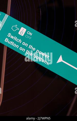 Switch on the power, button on the bottom - sticker label on robotic vacuum cleaner Stock Photo