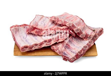 pieces of pork ribs isolated on board white background. Racks of fresh raw pork meat ribs isolated on white background Stock Photo