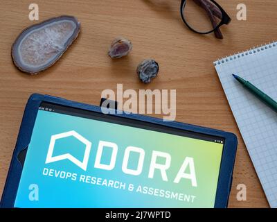 In this photo illustration DevOps Research and Assessment LLC owned by Alphabet Inc. logo seen displayed on a tablet Stock Photo