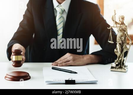 Law, Consultation, Agreement, Contract, Concept Attorney or lawyer focusing on the court hammer is sitting on the chair with a client's complaint to Stock Photo