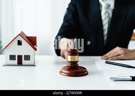 Law, Consultation, Agreement, Contract, Concept Attorney or lawyer focusing on the court hammer is sitting on the chair with a client's complaint to Stock Photo