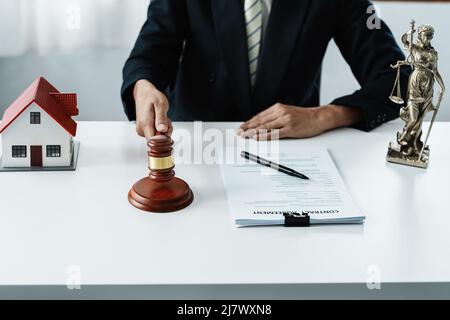 Law, Consultation, Agreement, Contract, Concept Attorney or lawyer focusing on the court hammer is sitting on the chair with a client's complaint to Stock Photo