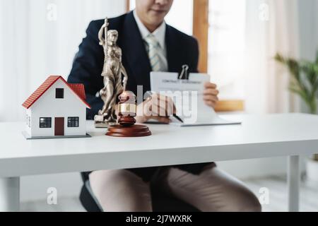 Law, Consultation, Agreement, Contract, Concept Attorney or lawyer focusing on the court hammer is sitting on the chair with a client's complaint to Stock Photo