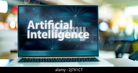 Laptop computer displaying a sign of artificial intelligence, robotics and fourth industrial revolution Stock Photo