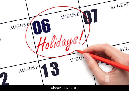 6th day of August. Hand drawing a red circle and writing the text Holidays on the calendar date 6 August. Important date. Summer month, day of the yea Stock Photo