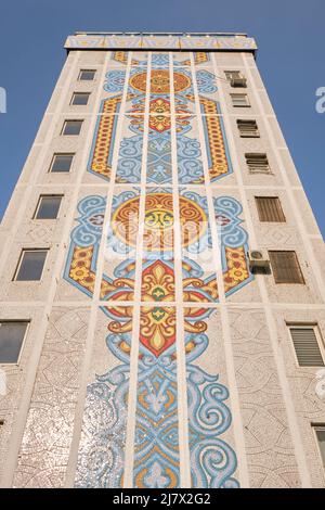Vertical view of an abstract design. Iconic tile mosaic mural design on the end of an apartment building in Tashkent, Uzbekistan. Stock Photo